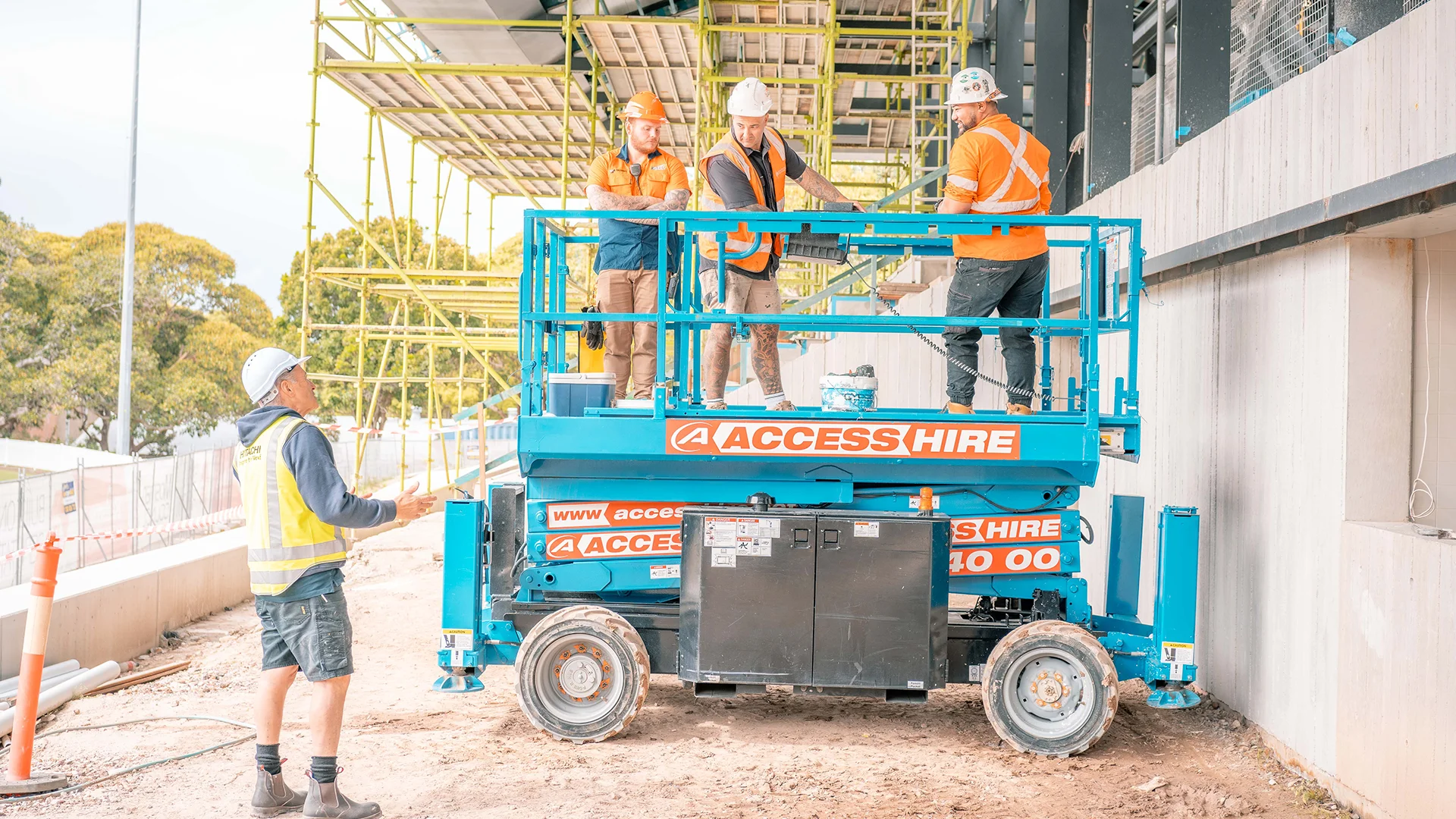 Workers on glass lifting equipment at Mosman Oval